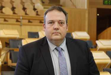Jamie Halcro Johnston standing in Parliament